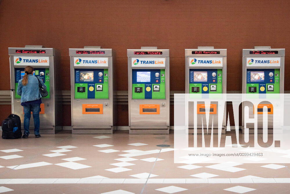 A woman is seen at a ticket vending machine at an empty train station during Coronavirus crisis..Australian states including Queensland take strict new lockdown rules to stop the spread of Covid-19. Queensland Australia - ZUMAs197 20200416_zaa_s197_004