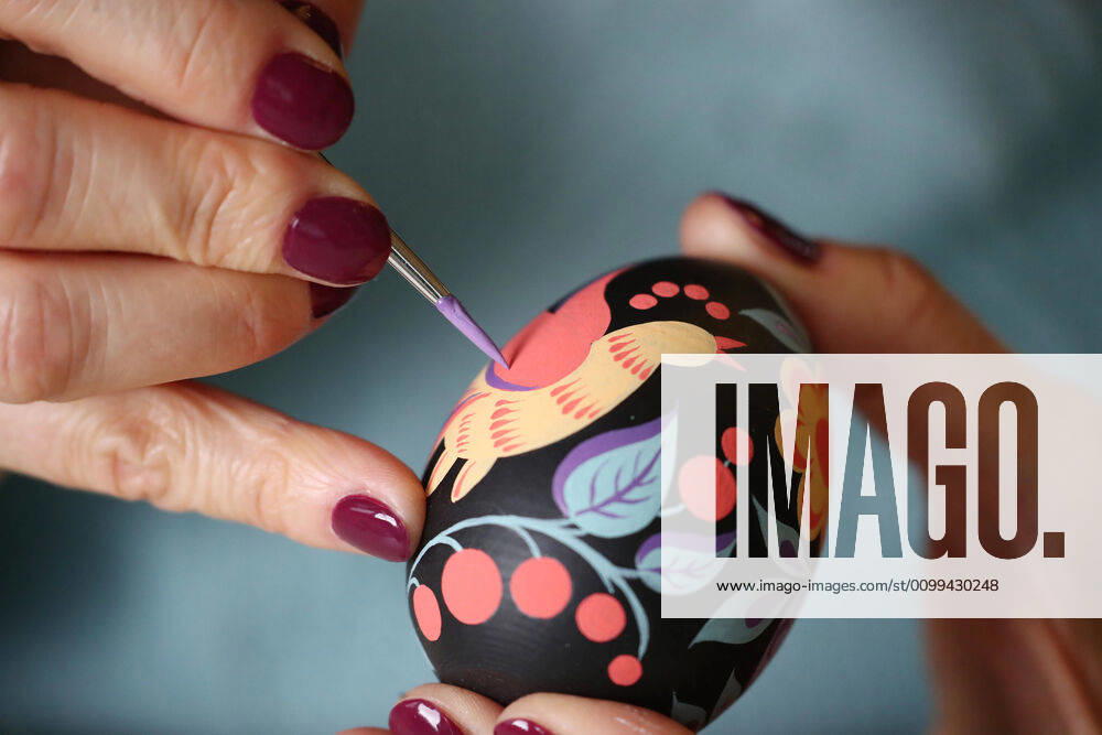 Artist Iya Tokareva paints a wooden Easter egg Gorodets-style at her home studio; Gorodets painting, one of the traditional Russians handicrafts, originated in the middle of XIX century in the town of Gorodets, the Nizhny Novgorod Region. Anton Novoderezhkin TASS TS0D5FDF