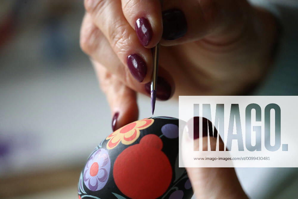 Artist Iya Tokareva paints a wooden Easter egg Gorodets-style at her home studio; Gorodets painting, one of the traditional Russians handicrafts, originated in the middle of XIX century in the town of Gorodets, the Nizhny Novgorod Region. Anton Novoderezhkin TASS TS0D5FE3
