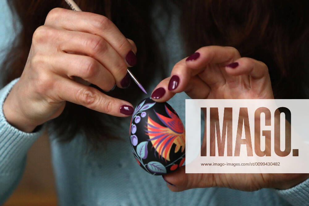 Artist Iya Tokareva paints a wooden Easter egg Gorodets-style at her home studio; Gorodets painting, one of the traditional Russians handicrafts, originated in the middle of XIX century in the town of Gorodets, the Nizhny Novgorod Region. Anton Novoderezhkin TASS TS0D5FE4