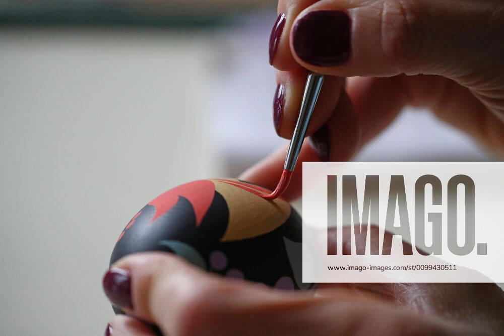 Artist Iya Tokareva paints a wooden Easter egg Gorodets-style at her home studio; Gorodets painting, one of the traditional Russians handicrafts, originated in the middle of XIX century in the town of Gorodets, the Nizhny Novgorod Region. Anton Novoderezhkin TASS TS0D5FF1