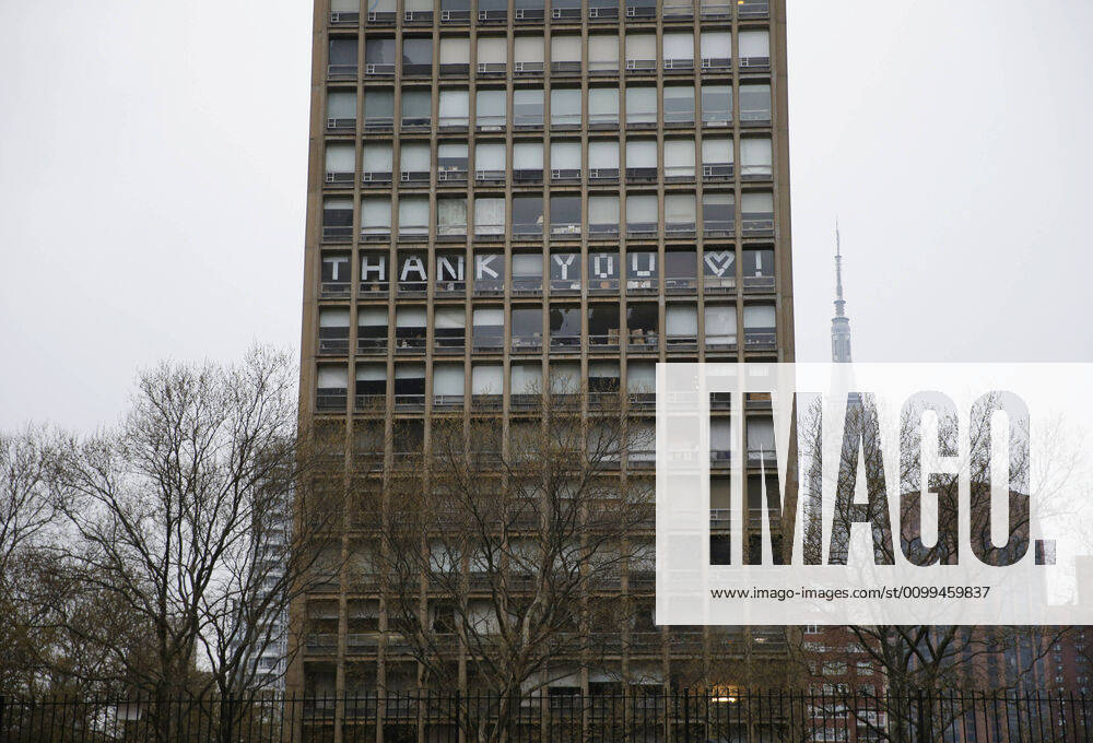 The words Thank You is spelled out in the windows of a building directly across from NYU Langone hospital when FDNY firefighters, NYPD police officers and pedestrians applaud and show their gratitude to medical staff and essential workers on the front lines of the coronavirus pandemic in New York City on Friday, April 17, 2020. The city s coronavirus death toll continued to climb with over 700 new COVID-19 fatalities bringing the total to over 12,000 to date. NYP20200417113 JOHNxANGELILLO
