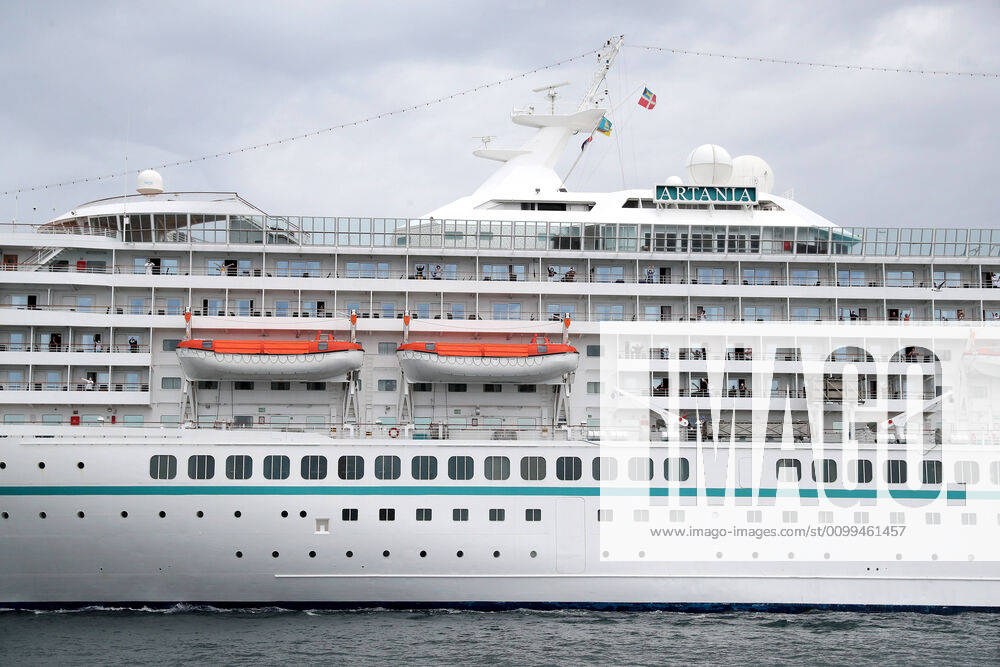 ARTANIA CRUISE SHIP DEPARTURE, Crew members on the cruise ship MV Artania are seen waving goodbye as it departs Fremantle harbour on Saturday, April 18, 2020. The MV Artania arrived in Fremantle over three weeks ago and a reported 79 crew and passengers have tested positive for coronavirus. Two crew members and one passenger have died from the virus.( NO ARCHIVING, , NO USE IN BOOKS WITHOUT CONSENT PERTH WA AUSTRALIA