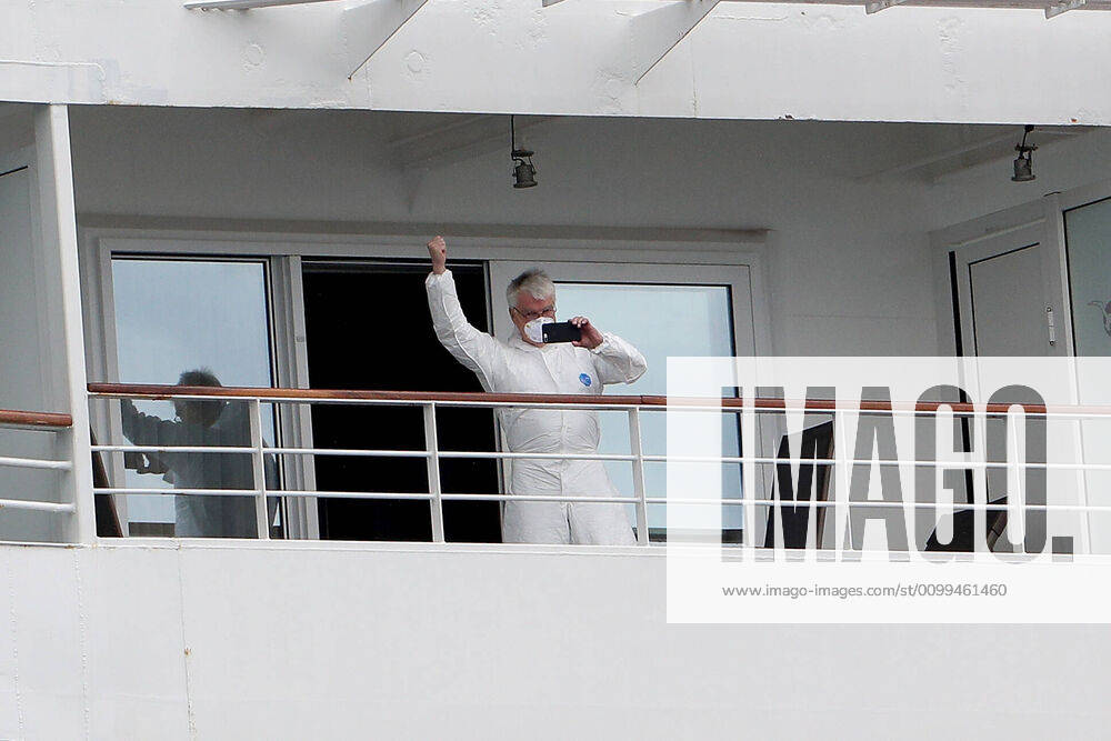 ARTANIA CRUISE SHIP DEPARTURE, A crew member on the cruise ship MV Artania is seen waving goodbye as it departs Fremantle harbour on Saturday, April 18, 2020. The MV Artania arrived in Fremantle over three weeks ago and a reported 79 crew and passengers have tested positive for coronavirus. Two crew members and one passenger have died from the virus.( NO ARCHIVING, , NO USE IN BOOKS WITHOUT CONSENT PERTH WA AUSTRALIA
