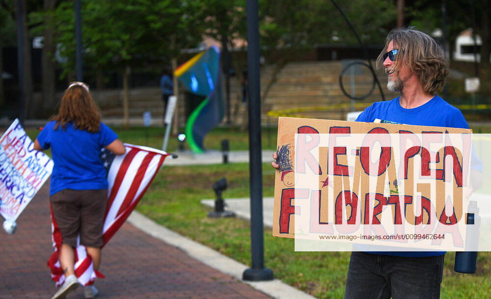Protesters demonstrate outside the Orange County Administration Building demanding the end of stay-at-home orders and the reopening of Florida businesses as the COVID-19 pandemic keeps thousands of people in their homes and out of work. Orlando United States - ZUMAs197 20200417_zaa_s197_227