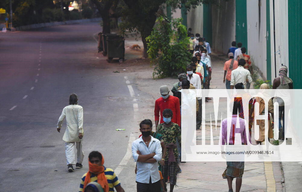 Stranded migrant workers and homeless people queue to collect food at Safdarjung Enclave during lockdown, on April 14, 2020 in New Delhi, India. (Photo by Amal KS Hindustan Times ) Government And NGOs Provide Food To Homeless And Poor Amid Lockdown To Prevent Covid-19