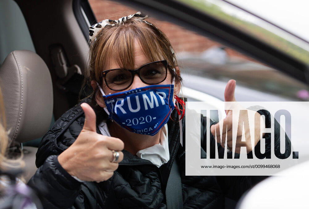 A woman wears a Trump face mask as she participates in a car protest to reopen Maryland and end the stay at home order imposed during the Coronavirus COVID-19 pandemic, near the state capitol building in Annapolis, Maryland on Saturday, April 18, 2020. WAP20200418307 KEVINxDIETSCH