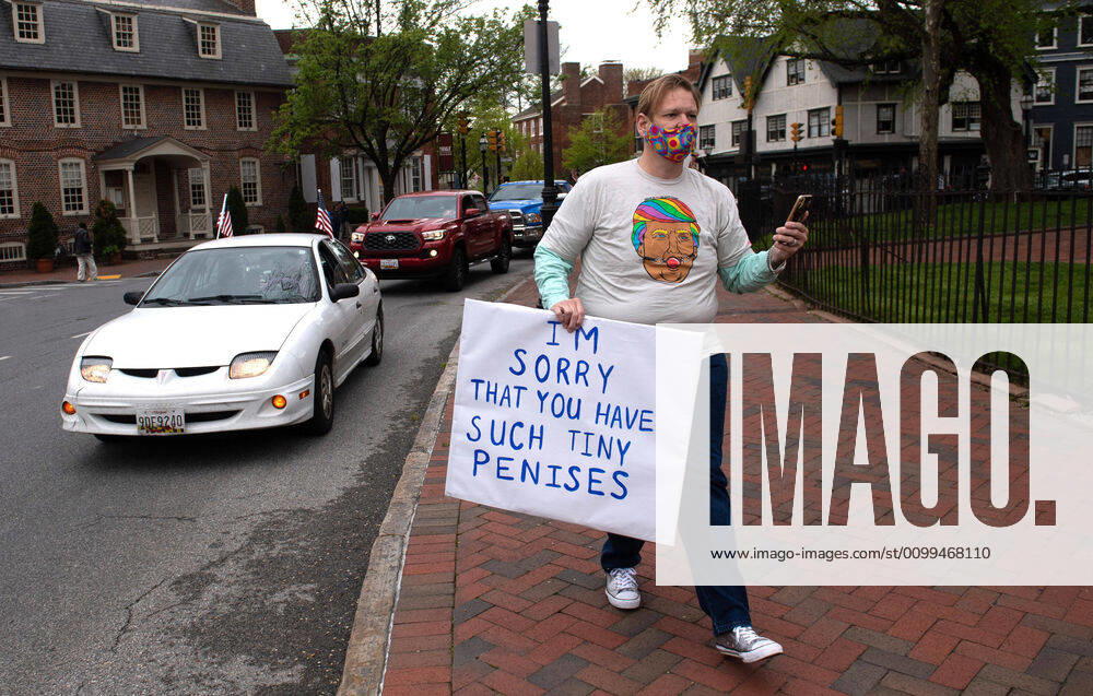 A counter protester demonstrates alongside vehicles participating in a car protest to reopen Maryland and end the stay at home order imposed during the Coronavirus COVID-19 pandemic, near the state capitol building in Annapolis, Maryland on Saturday, April 18, 2020. Drivers circled Annapolis hoking their horns and calling for Gov. Larry Hogan (R-MD) to end the stay at home order. WAP20200418339 KEVINxDIETSCH