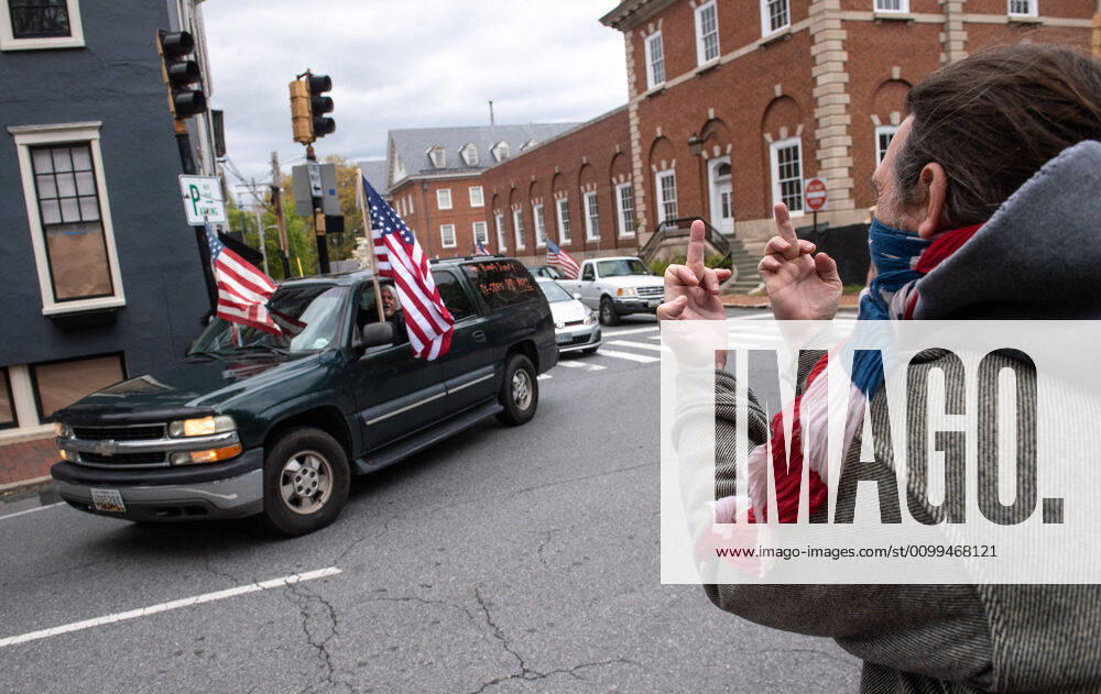 A counter protester reacts to protesters in their vehicles as they participate in a car protest to reopen Maryland and end the stay at home order imposed during the Coronavirus COVID-19 pandemic, near the state capitol building in Annapolis, Maryland on Saturday, April 18, 2020. Drivers circled Annapolis hoking their horns and calling for Gov. Larry Hogan (R-MD) to end the stay at home order. WAP20200418352 KEVINxDIETSCH