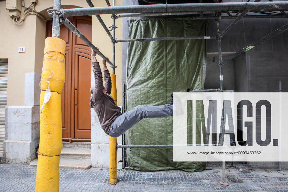 April 18, 2020 (Malaga) 70 year old adult takes advantage at the door of his portal and due to the stress of absolute confinement to do some exercise in front of his house and breathe fresh air due to the crisis of the coronavirus - ZUMAc161 20200418_zap_c161_045