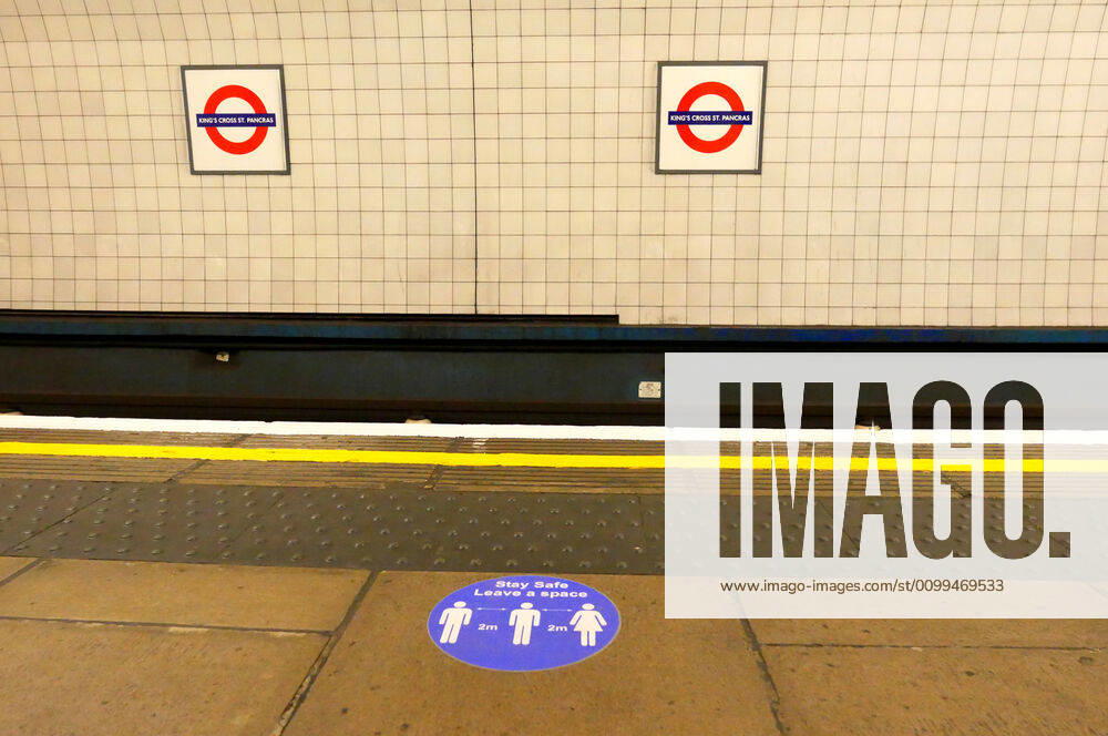 Day Twenty Six of Lockdown in London. Stickers on the platform advising of social distancing at London Kings Cross underground station on a very quiet Saturday as the country is on lockdown due to the COVID-19 Coronavirus pandemic. People are not allowed to leave home except for minimal food shopping, medical treatment, exercise - once a day, and essential work. COVID-19 Coronavirus lockdown, London, UK, on April 18, 2020