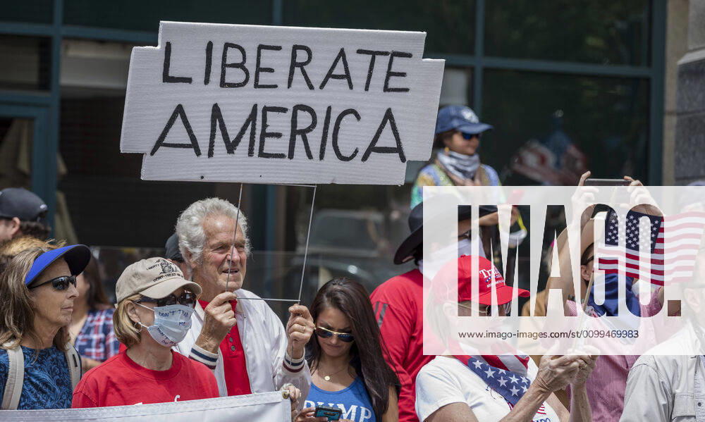 Protesters at a Liberate San Diego rally in downtown San Diego on Saturday waved signs and held banners complaining that they wanted the state to lift its stay at home order, a measure meant to reduce the spread of the coronavirus. The event was clearly political, with an overwhelming amount of signs and banners supporting President Trump. San Diego US - ZUMAp23_ 20200418_zaf_p23_003