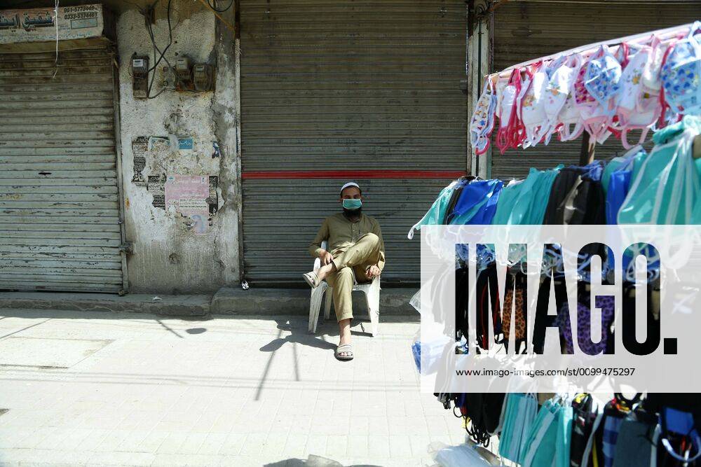 (200419) -- RAWALPINDI, April 19, 2020 -- A man sells masks in front of a closed shop in Rawalpindi of eastern Pakistan s Punjab province on April 19, 2020. ) PAKISTAN-RAWALPINDI-COVID-19-DAILY LIFE AhmadxKamal