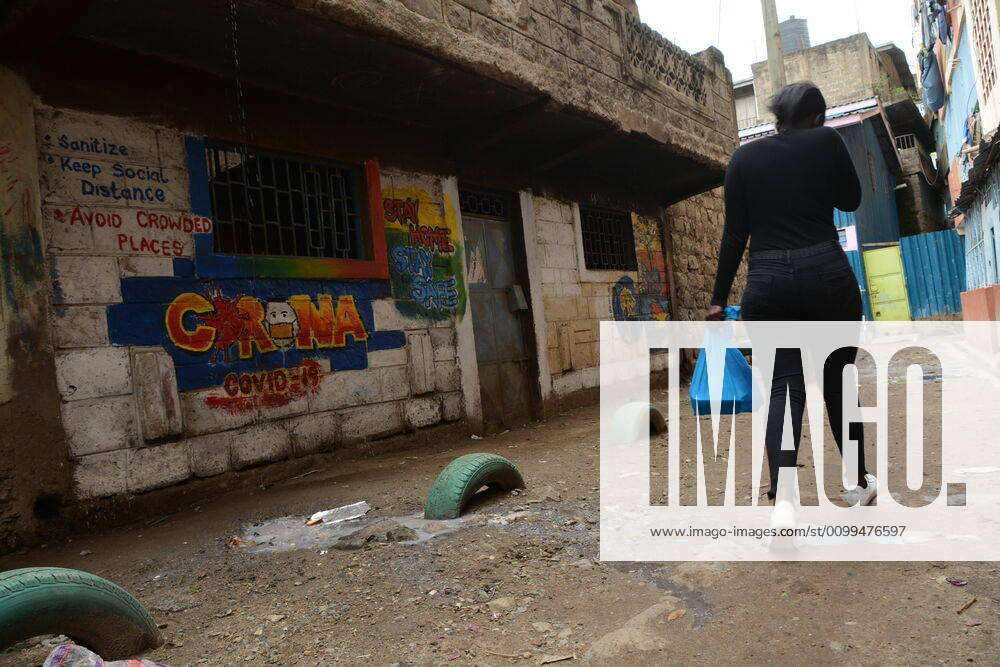 A woman walks past a graffiti by Anthony Kihoro in Kayole sensitising people about Coronavirus..President Uhuru Kenyatta on March 25, 2020 imposed a dusk-to-dawn 21 day curfew from (7pm-5am) that took effect on Friday, March 26, 2020 in order to curb the spread of COVID-19. Kenya has so far recorded 270 cases of the Coronavirus, 67 recoveries and 14 deaths. Nairobi Kenya - ZUMAs197 20200419_zab_s197_001