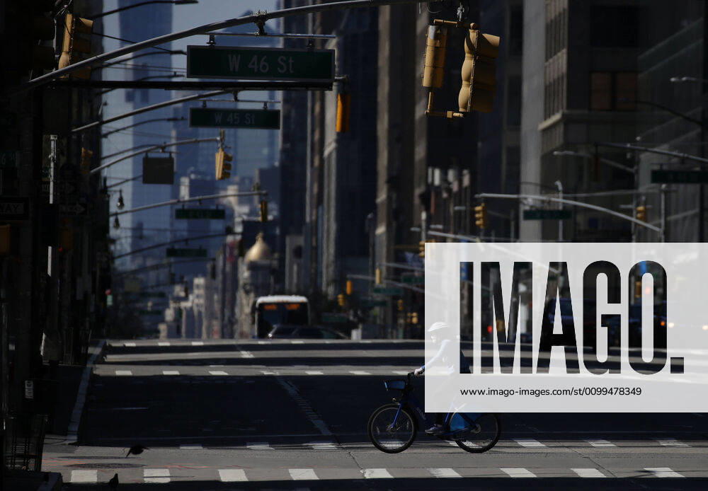 A biker wearing a protective face mask crosses a nearly empty 5th Avenue on Easter Sunday of Orthodox Easter weekend in New York City on Sunday, April 19, 2020. The world s Orthodox Christians are celebrating Easter through a series of restrictions and bans including closures of churches due to the Coronavirus pandemic. More than 13,300 people with COVID-19 have died in New York State. NYP20200419113 JOHNxANGELILLO