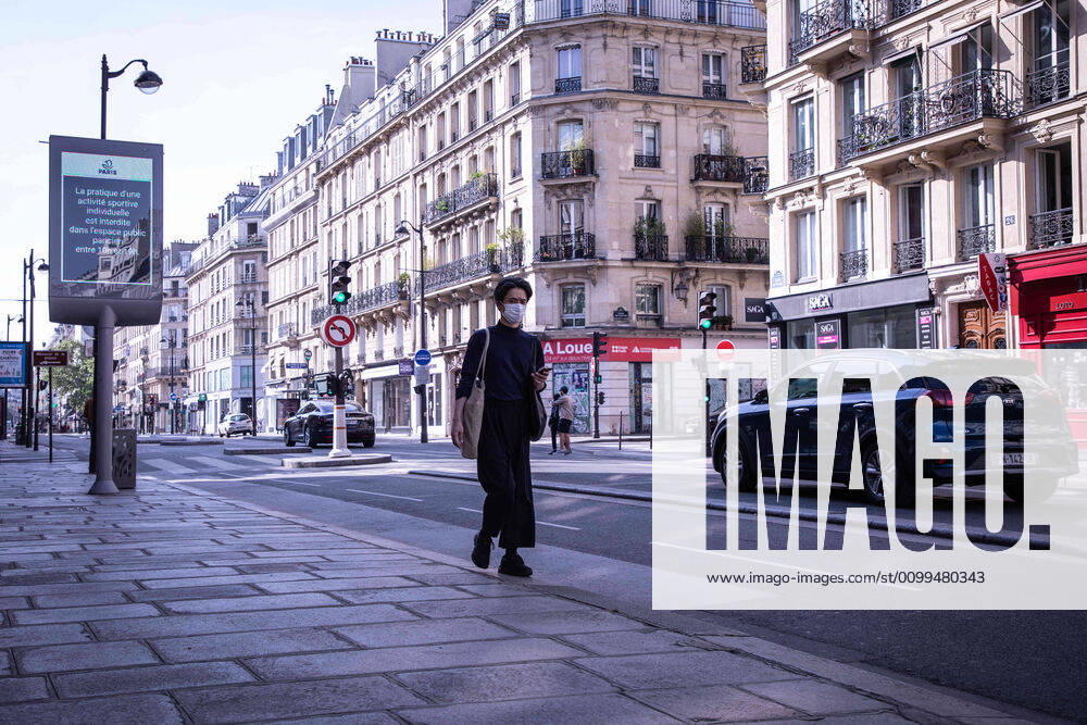 A man wearing a face mask as a preventive measure from coronavirus, walks along an almost deserted street during the quarantine..France has recorded 112606 confirmed cases, 36578 recovered and 19718 deaths by the corona virus. Paris France - ZUMAs197 20200419_zaa_s197_089