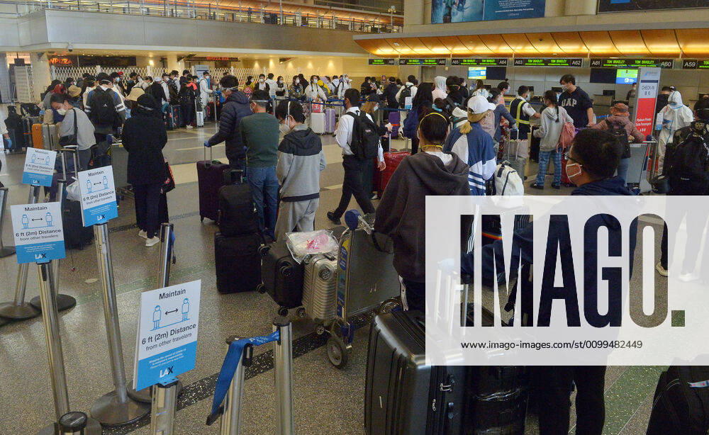 Hundreds of passengers form a line to check-in and board a China Southern Airlines midnight flight to China on Sunday, April 19, 2020 in Los Angeles. Passengers at the front of the line arrived at 5:30 a.m., with many others standing in line since 8 a.m. to ensure they would have a seat before the plane was full. Mayor Eric Garcetti said 95% of air travel has stopped in his city as Los Angeles sees the biggest drop of airplane travel in LAX history. LAP2020041921 JIMxRUYMEN