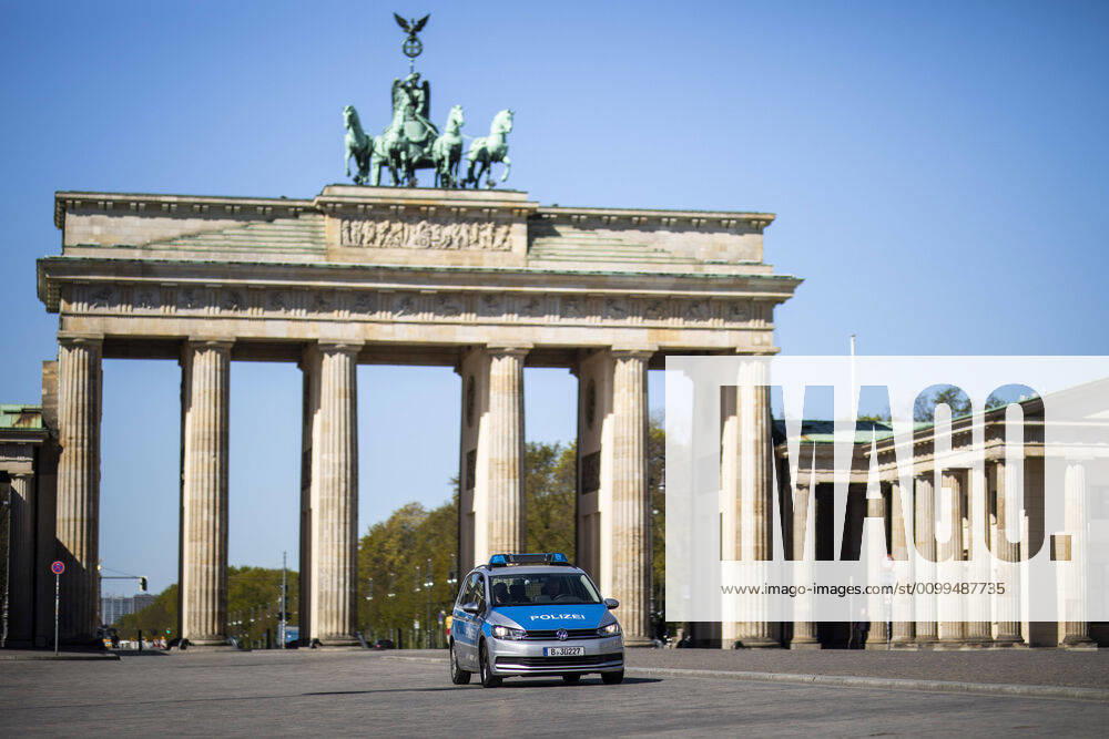 A police car is parked in front of the Brandenburg Gate in Berlin, 20 04 2020 Due to the spread of the coronavirus there are contact restrictions throughout Germany Berlin Germany