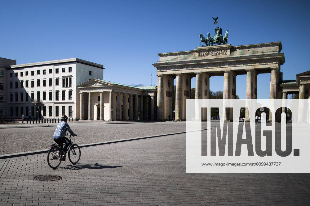 A single cyclist rides on Pariser Platz in front of the Brandenburg Gate, recorded in Berlin, 20 04 2020 Due to the spread of the coronavirus there are contact restrictions throughout Germany Berlin Germany