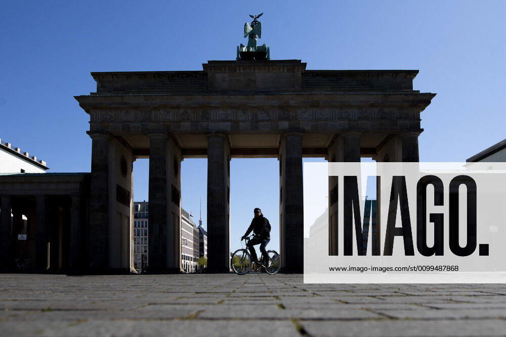A single cyclist rides on Pariser Platz in front of the Brandenburg Gate, recorded in Berlin, 20 04 2020 Due to the spread of the coronavirus there are contact restrictions throughout Germany Berlin Germany
