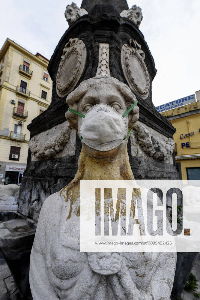 A protective mask is placed on a statue of a sphinx in Piazza Mercato (Marketplace Square), one of the most symbolic and historical places in Naples. Government Decree declaring all of Italy a protected area to combat Covid-19 - Coronavirus infection.