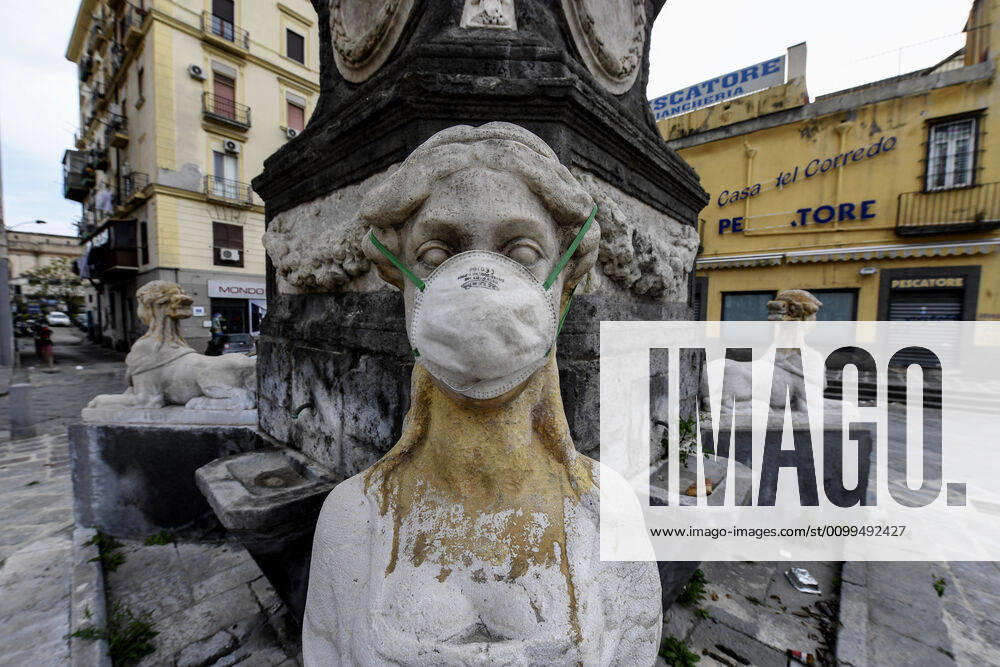 A protective mask is placed on a statue of a sphinx in Piazza Mercato (Marketplace Square), one of the most symbolic and historical places in Naples. Government Decree declaring all of Italy a protected area to combat Covid-19 - Coronavirus infection.