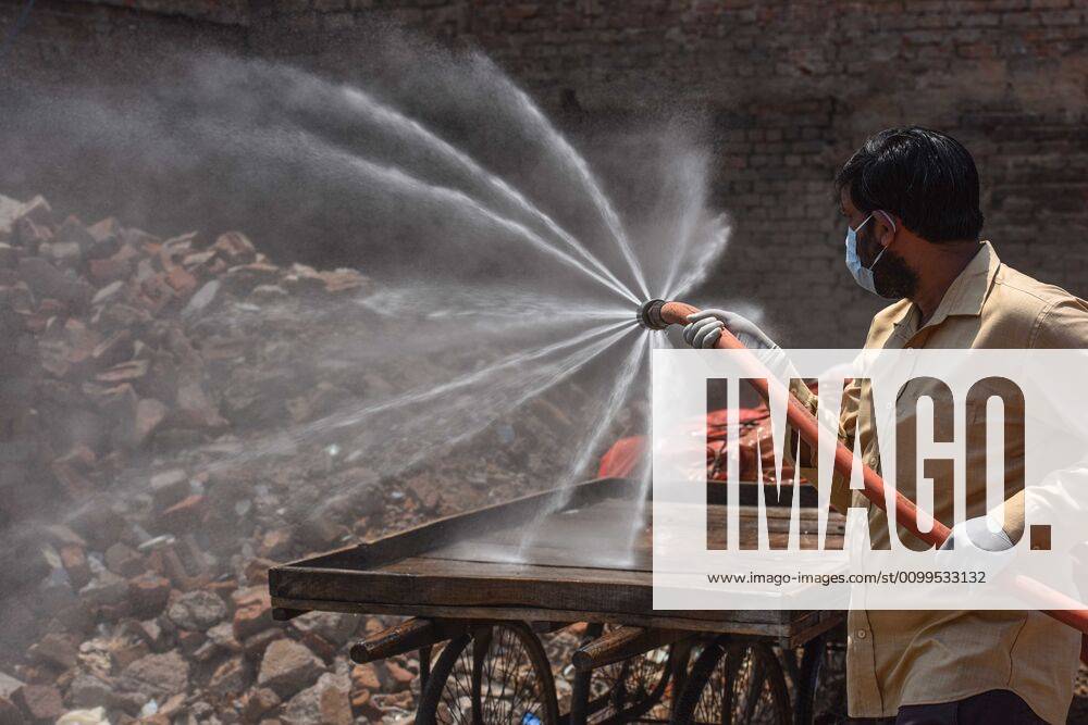 MCD worker chemically sanitizes an area in Jahangirpuri C Block one of the coronavirus containment zone, on April 21, 2020 in New Delhi, India. (Photo by Sanchit Khanna Hindustan Times) Sanitization Drive To Curb The Spread Of Coronavirus COVID-19