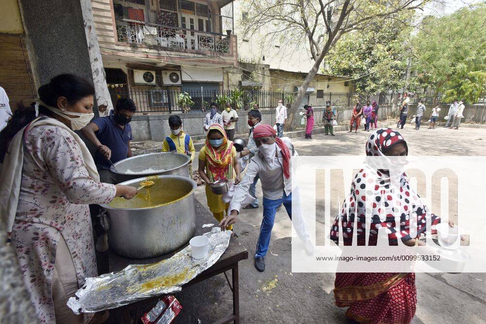 People queue to collect food distributed by BJP councilor Shikha Rai during lockdown to curb spread of coronavirus, at Shahpur Jat, on April 21, 2020 in New Delhi, India. (Photo by Sanjeev Verma Hindustan Times) Government And NGOs Provide Food To Homeless And Poor Amid Lockdown To Prevent Covid-19 Pandemic