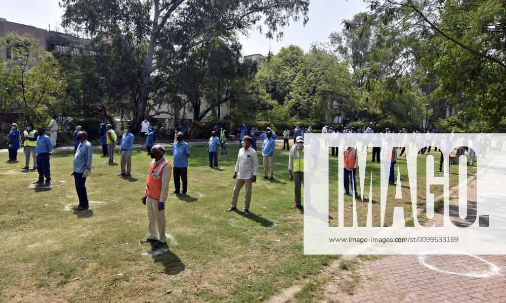 Cleaning staff queue to collect PPE kits distributed by Defence Colony welfare groups in association with SDMC during lockdown, at Defence Colony, on April 21, 2020 in New Delhi, India. (Photo by Sanjeev Verma Hindustan Times) PPE Kits Distributed To SDMC Sanitation Staff