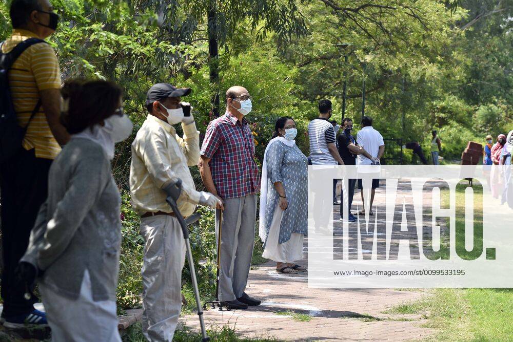Residents look on during a PPE kit distribution drive for cleaning staff by Defence Colony welfare groups in association with SDMC during lockdown, at Defence Colony, on April 21, 2020 in New Delhi, India. (Photo by Sanjeev Verma Hindustan Times) PPE Kits Distributed To SDMC Sanitation Staff