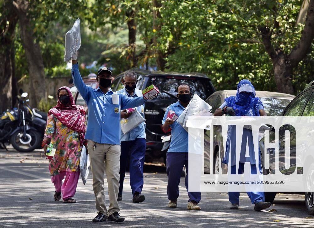 Cleaning staff leave after collecting PPE kits distributed by Defence Colony welfare groups in association with SDMC during lockdown, at Defence Colony, on April 21, 2020 in New Delhi, India. (Photo by Sanjeev Verma Hindustan Times) PPE Kits Distributed To SDMC Sanitation Staff