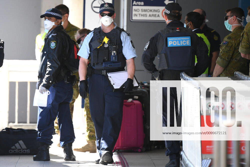 RUBY PRINCESS DEPARTURE, Australian Federal Police, NSW Police and Australian Defence Force personnel assist as crew from the Ruby Princess cruise ship are seen arriving at Sydney International Airport in Sydney, Thursday, April 23, 2020. The Ruby Princess cruise ship has been told to leave Australia by Thursday, as an inquiry begins. ( NO ARCHIVING, , NO USE IN BOOKS WITHOUT CONSENT SYDNEY NSW AUSTRALIA