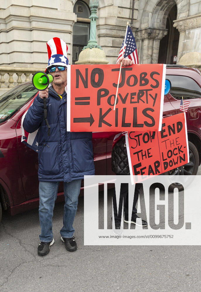 NY: Operation Gridlock in Albany People in cars and on streets with American flags and Trump flags participate in Operation Gridlock protest outside of New York State Capitol Building. Participants demanded reopening of New York State. Many people on the street disregarded wearing facial masks and keep social distances. Albany New York United States