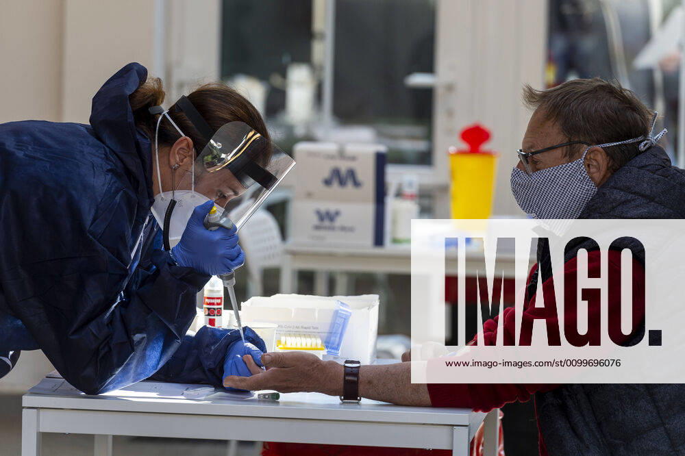 A medic takes a sample for a covid-19 test from a volunteer, on April 23, 2020, in Litomerice, Czech Republic. Across-the-board testing of population for new coronavirus began today. Test points open in Prague at 10:00, in Brno and Litomerice at 8:00. The goal is to find out the presence of coronavirus in Czech population. (CTKxPhoto OndrejxHajek) CTKPhotoP202004230261501 HAJ 02