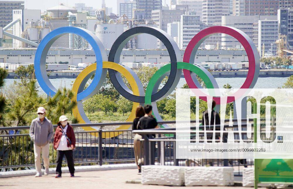 Olympic rings monument in Tokyo People walk near the Olympic rings in Tokyo s Odaiba waterfront area on April 23, 2020. The 2020 Tokyo Games have been postponed for about one year due to the coronavirus pandemic.