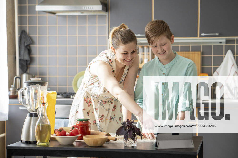 Mother and son using digital tablet in the kitchen model released Symbolfoto property released VPIF02238