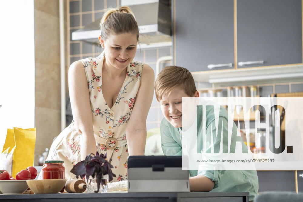 Mother and son using digital tablet in the kitchen model released Symbolfoto property released VPIF02239