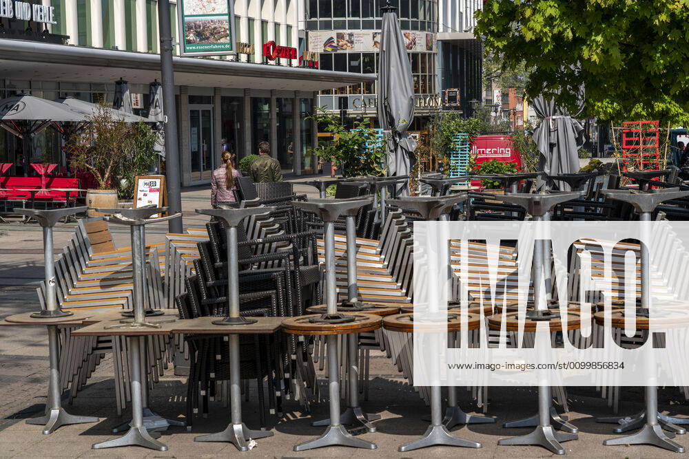 Stacked chairs and tables from various catering establishments, on Kennedyplatz, closed cafes, pubs, restaurants, effects of the corona crisis in Essen, Germany