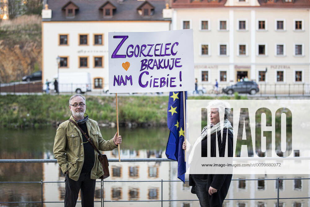 Demonstrators protesting with a sign saying Zgorzelec brakuje nam ciebie We are missing Zgorzelec against the closed border between Zgorzelec and Goerlitz, 24 04 2020 To contain the corona
