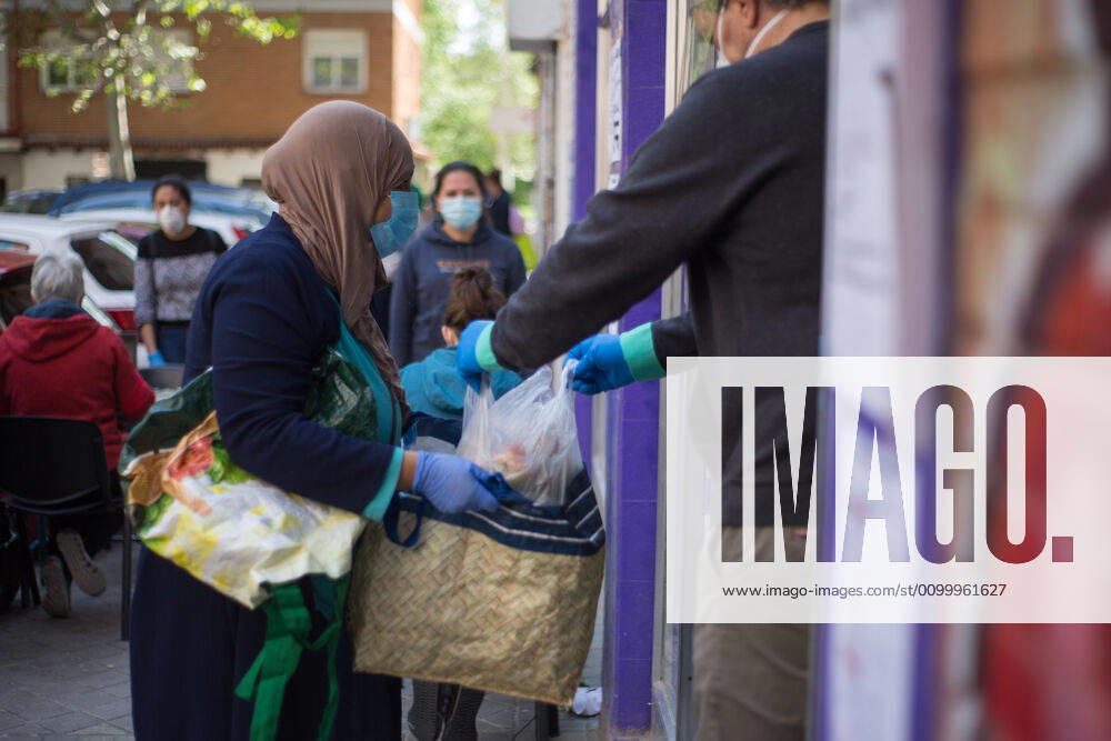 Spain: Food distribution due to Covid-19 crisis A person picks up a bag of food at the Aluche Neighbors Association Madrid Madrid Spain