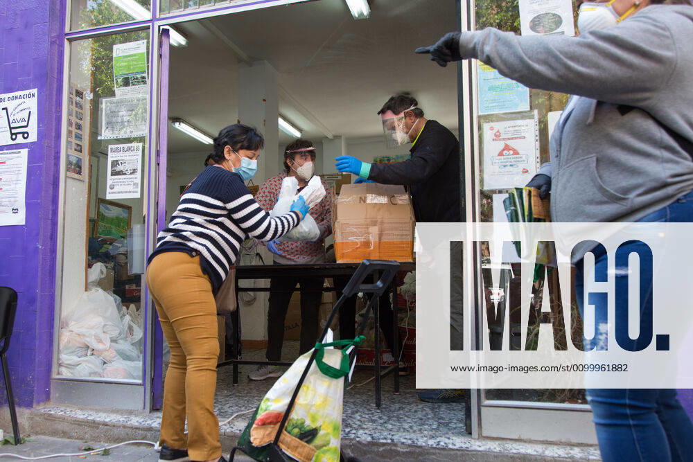 Spain: Food distribution due to Covid-19 crisis A person picks up a bag of food at the Aluche Neighbors Association Madrid Madrid Spain
