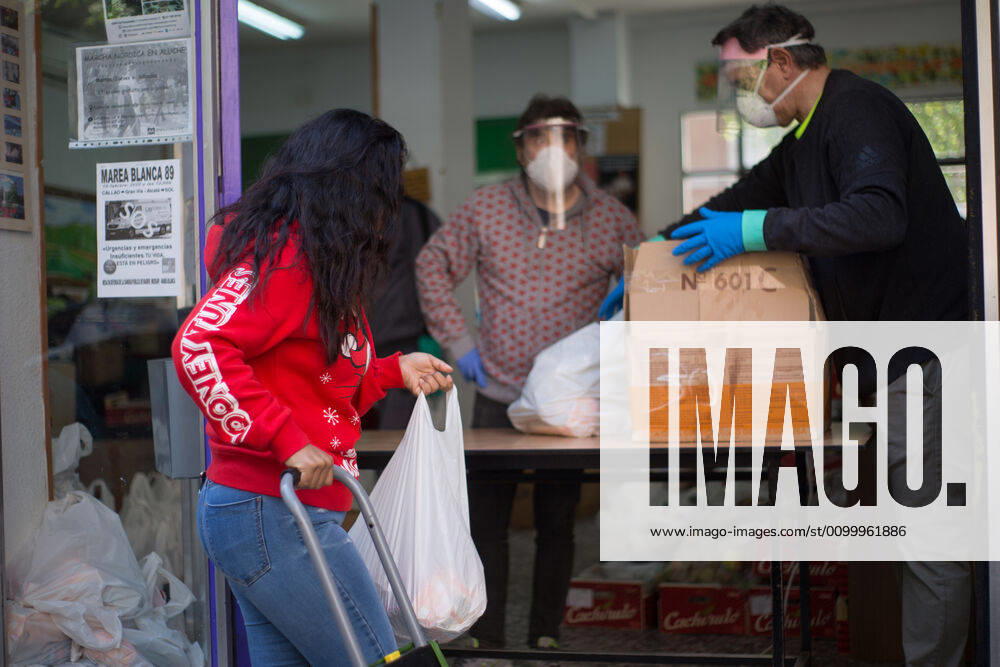 Spain: Food distribution due to Covid-19 crisis A person picks up a bag of food at the Aluche Neighbors Association Madrid Madrid Spain