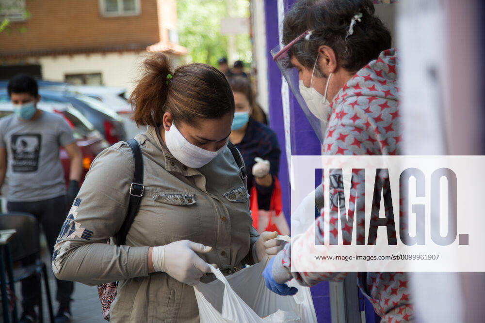 Spain: Food distribution due to Covid-19 crisis A person picks up a bag of food at the Aluche Neighbors Association Madrid Madrid Spain