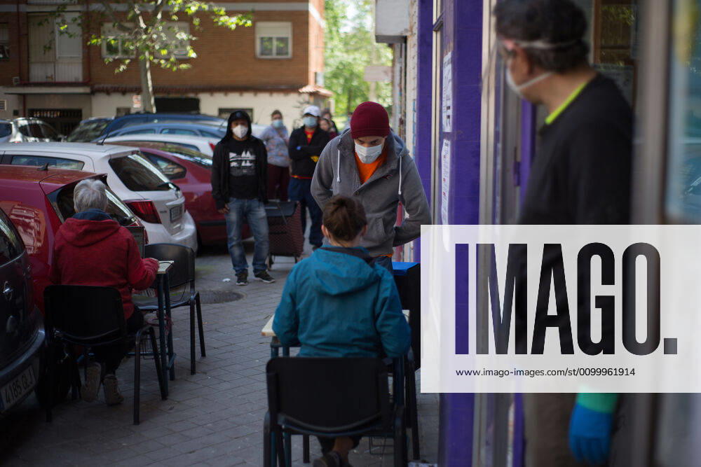 Spain: Food distribution due to Covid-19 crisis several people wait their turn to receive food. Madrid Madrid Spain