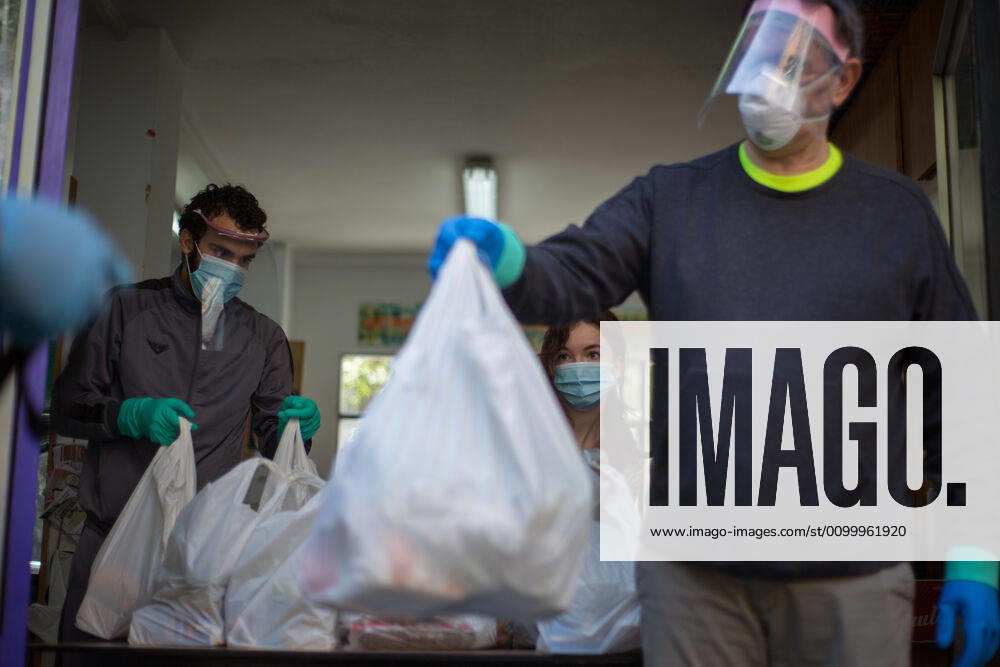 Spain: Food distribution due to Covid-19 crisis A volunteer delivers food at the Aluche Neighbors Association Madrid Madrid Spain