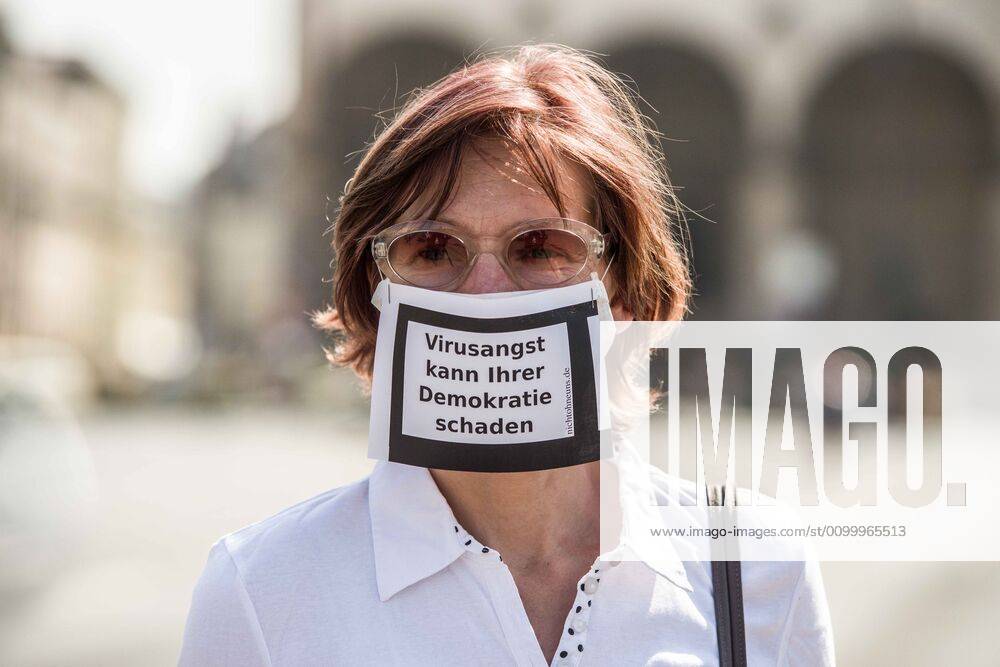 Virus fears can damage democracy worn by a woman during a conspiracy theorist demonstration in Munich, Germany. Organized in Telegram chats by conspiratorial â€oeQuerfront†(cross-front) groups, the city of Munich, Germany saw numerous anti-state â€oeCorona Parties†as under mottos such as â€oeDemonstration fuer die Erhaltung der Grundrechte†(Demonstration for the Upholding of Basic Rights) and â€oeFuer unsere Freiheit, unsere Grundrechte und unsere Selbstbestimmung†(Demonstration for our Freedom, Basic Rights, and Self-Determination). Numerous right-extremists, Verfassungsschutz-monitored figures, QAnon fans, and AfD politicians were in attendance. The groups are of the belief that the anti-Coronavirus measures are power-grabs. Querfront groups are o - ZUMAb160 20200425_zbp_b160_023