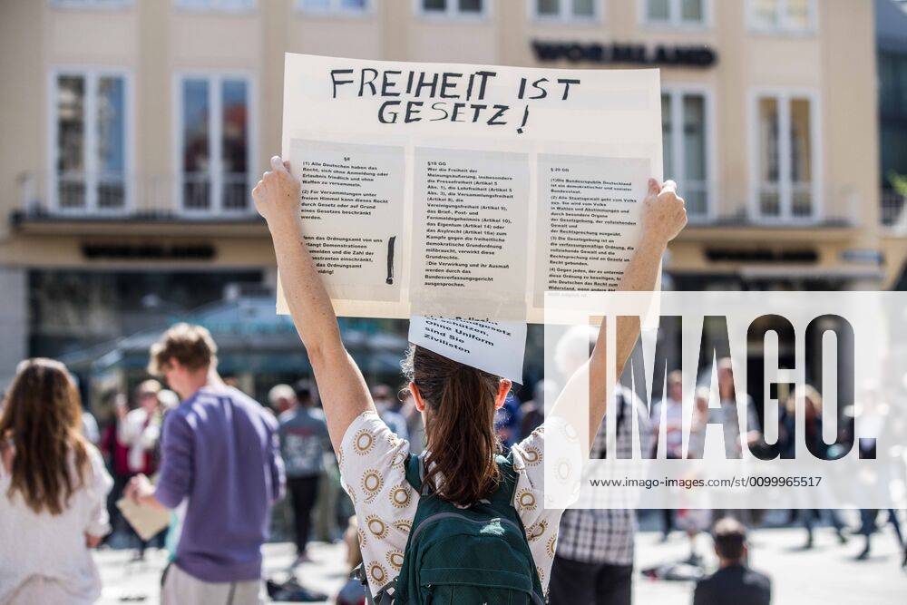 Freedom is law held up by a demonstrator at a conspiracy theorist demo in Munich, Germany. Organized in Telegram chats by conspiratorial â€oeQuerfront†(cross-front) groups, the city of Munich, Germany saw numerous anti-state â€oeCorona Parties†as under mottos such as â€oeDemonstration fuer die Erhaltung der Grundrechte†(Demonstration for the Upholding of Basic Rights) and â€oeFuer unsere Freiheit, unsere Grundrechte und unsere Selbstbestimmung†(Demonstration for our Freedom, Basic Rights, and Self-Determination). Numerous right-extremists, Verfassungsschutz-monitored figures, QAnon fans, and AfD politicians were in attendance. The groups are of the belief that the anti-Coronavirus measures are power-grabs. Querfront groups are often a mix of politic - ZUMAb160 20200425_zbp_b160_024