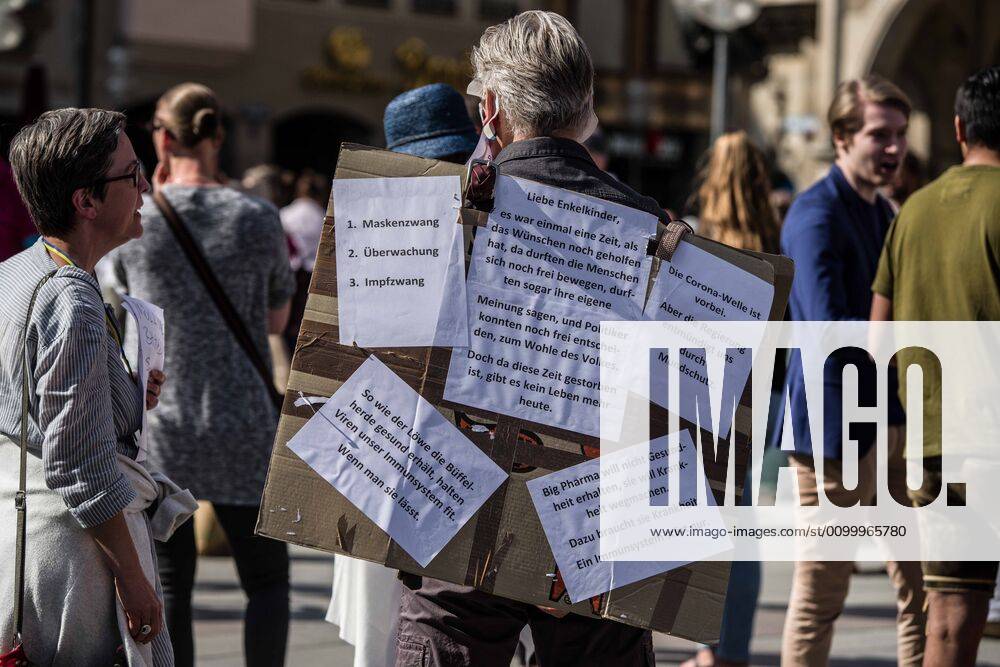 A man with various conspiracies written on his board during a QAnon-like demo in Munich, Germany. Organized in Telegram chats by conspiratorial â€oeQuerfront†(cross-front) groups, the city of Munich, Germany saw numerous anti-state â€oeCorona Parties†as under mottos such as â€oeDemonstration fuer die Erhaltung der Grundrechte†(Demonstration for the Upholding of Basic Rights) and â€oeFuer unsere Freiheit, unsere Grundrechte und unsere Selbstbestimmung†(Demonstration for our Freedom, Basic Rights, and Self-Determination). Numerous right-extremists, Verfassungsschutz-monitored figures, QAnon fans, and AfD politicians were in attendance. The groups are of the belief that the anti-Coronavirus measures are power-grabs. Querfront groups are often a mix of poli - ZUMAb160 20200425_zbp_b160_035