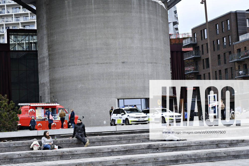 Police patrol while Copenhageners enjoy spring sun at Gothenburg Plads and Sandkaj in Nordhavnen in Copenhagen on Sunday, April 26, 2020 There is a ban on more than ten people because of the danger of infection with coronavirus covid 19, Copenhagen Denmark,
