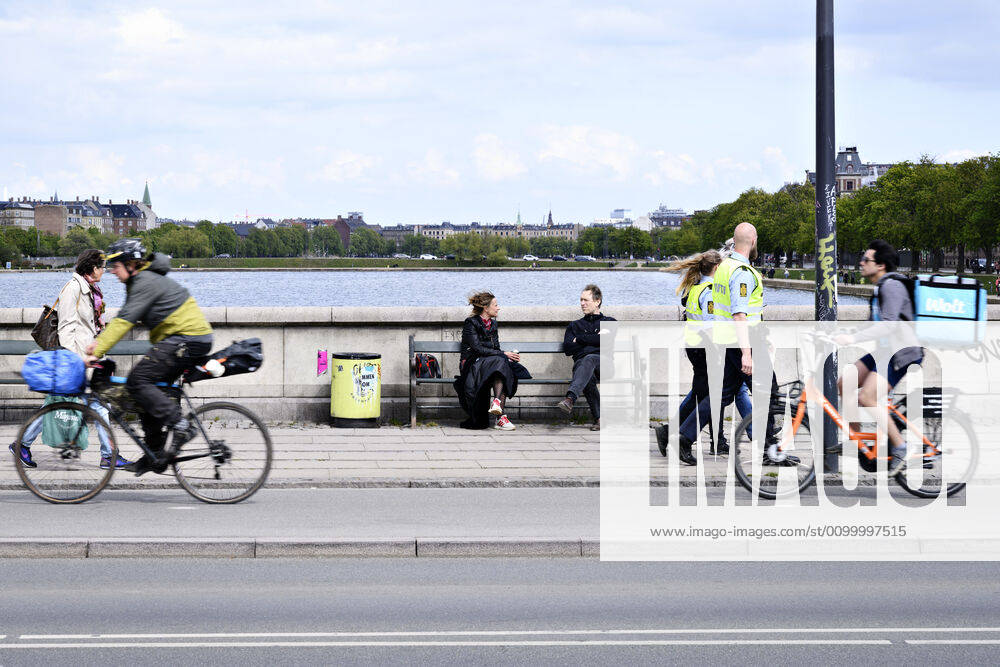 Police patrol while Copenhageners enjoy spring sun on Queen Louises Bridge in Copenhagen on Sunday, April 26, 2020 There is a ban on assembly of over ten people because of the danger of infection with coronavirus covid 19, Copenhagen Denmark,